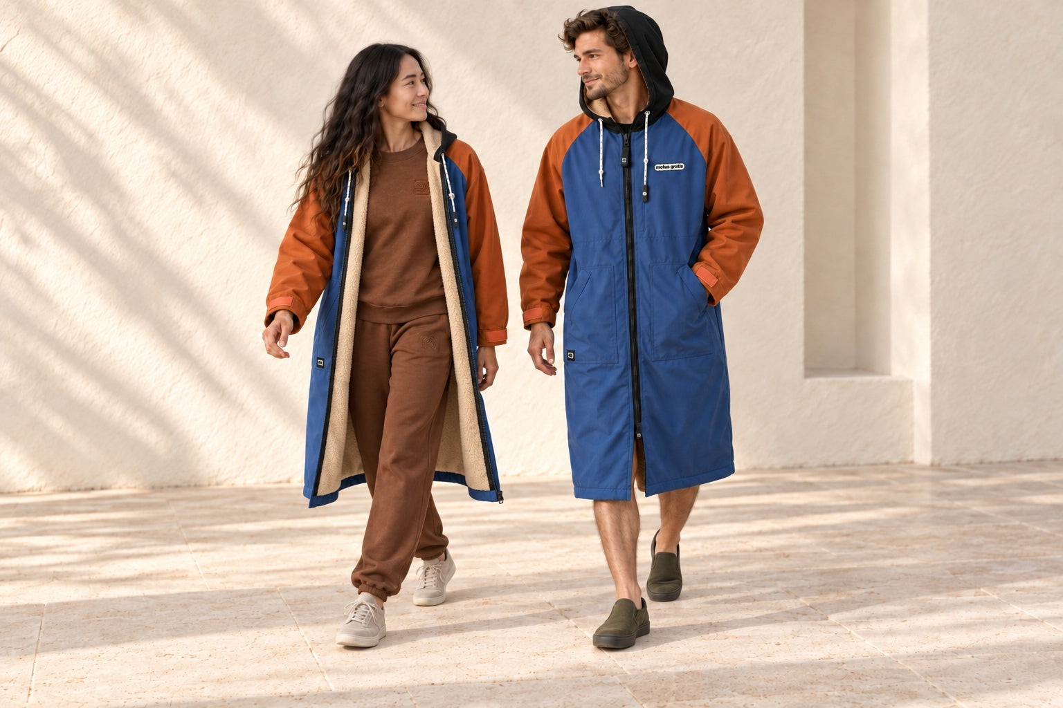 Fashion models wearing blue and orange TOGHA robes, including an open robe over a brown sweat set.