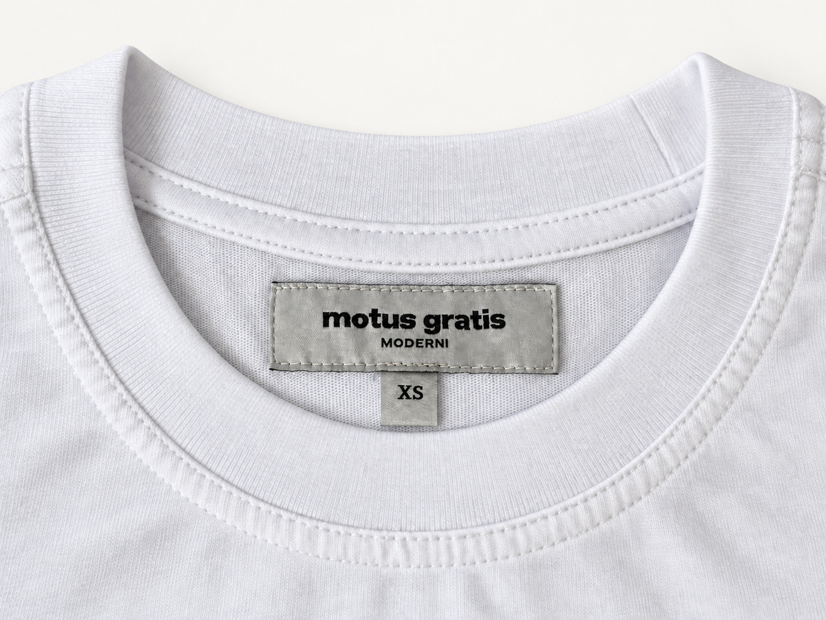 White Moderni unisex T-shirt interior neck label and ribbed collar, showing Motus Gratis, MODERNI and XS